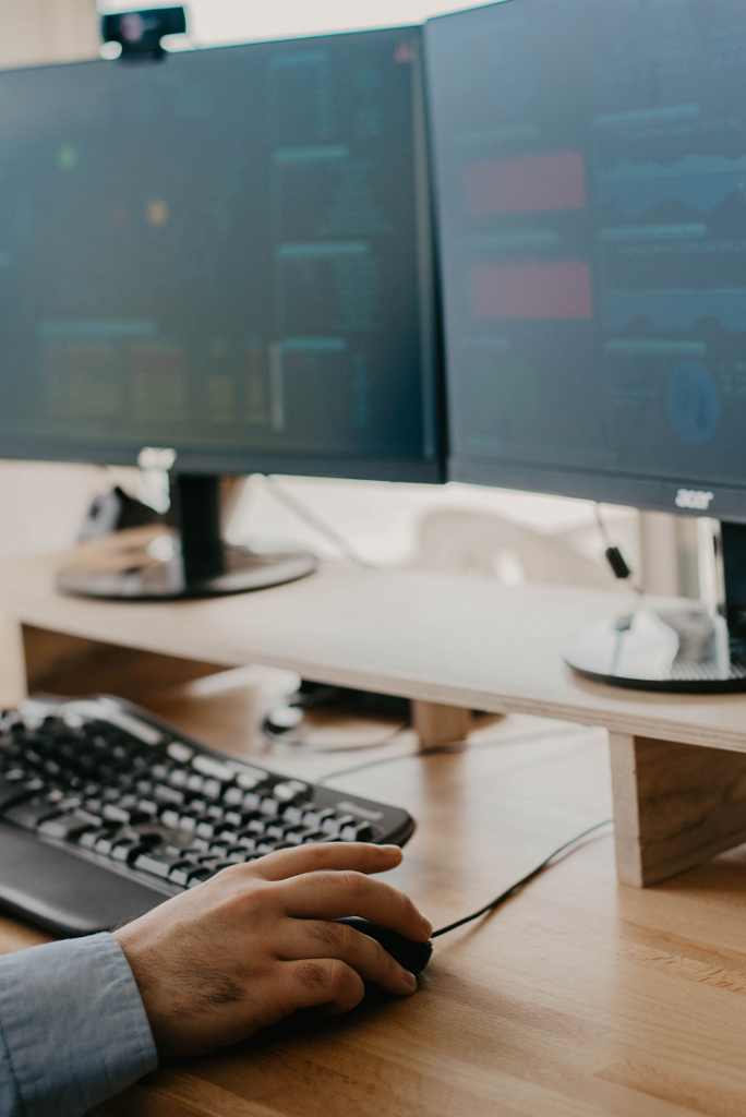 Computer screens with hand moving mouse